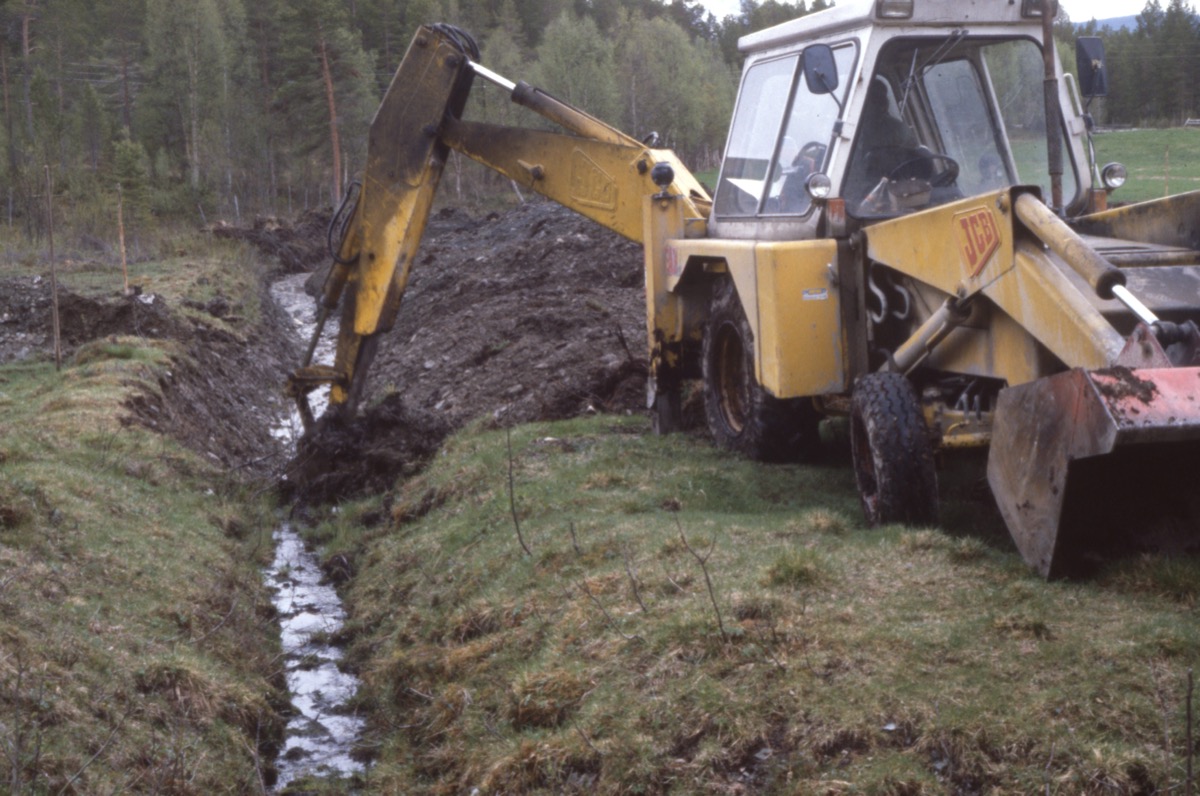 Backhoe loader digging a trench