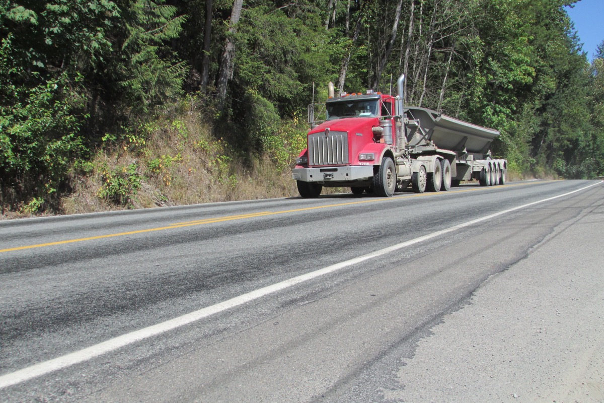 Tri-axle dump truck on the road